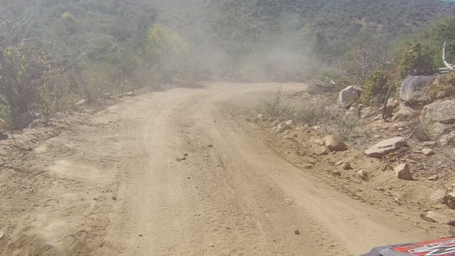 LOS CABOS BCS MEXICO-2022: Vehicle Driving on Dusty Dirt Road Through Dry Terrain