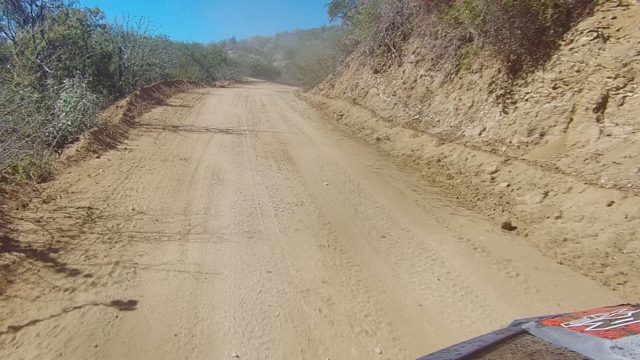 LOS CABOS BCS MEXICO-2022: Vehicle Navigating Winding Dirt Road Through Arid Hills