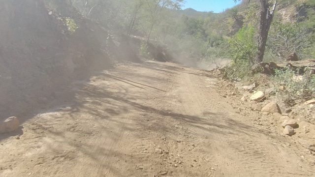 LOS CABOS BCS MEXICO-2022: Dust Cloud From Vehicle on Winding Dirt Road