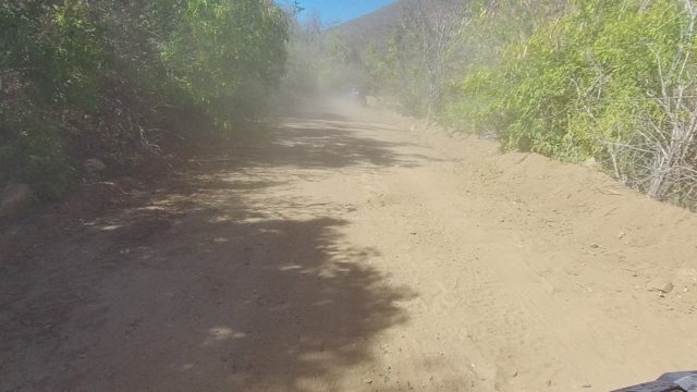 LOS CABOS BCS MEXICO-2022: Dust Cloud From Vehicle on Winding Dirt Road