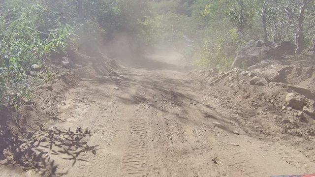 LOS CABOS BCS MEXICO-2022: Dust Cloud From Vehicle on Winding Dirt Road