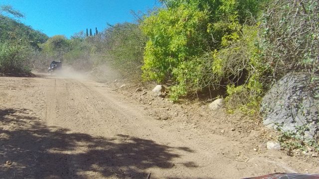 LOS CABOS BCS MEXICO-2022: Vehicle Drives on Dusty Arid Dirt Road