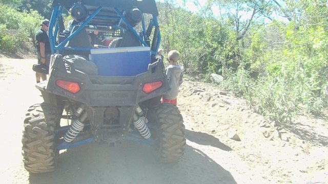 LOS CABOS BCS MEXICO-2022: People Interacting with a Blue Off-road Vehicle on a Dirt Path