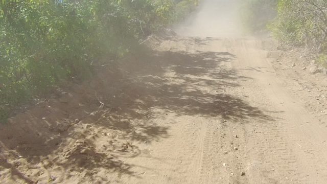 LOS CABOS BCS MEXICO-2022: Dusty Dirt Road with Vehicle Approaching