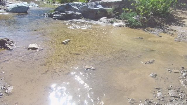 LOS CABOS BCS MEXICO-2022: Vehicle Splashing Through Shallow Stream on Dirt Road