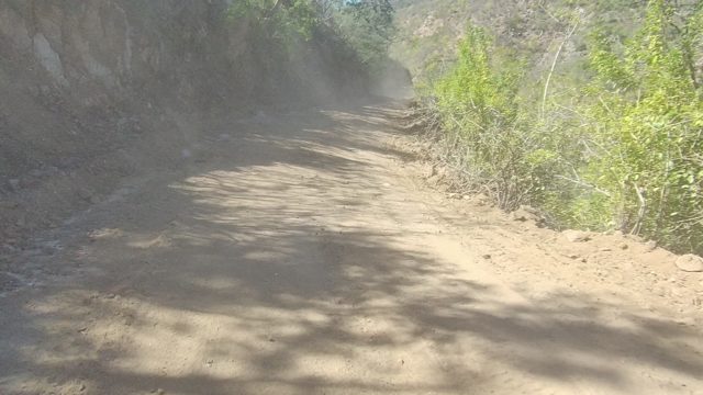 LOS CABOS BCS MEXICO-2022: Vehicle Traveling on Narrow Dirt Road Through Hilly Terrain
