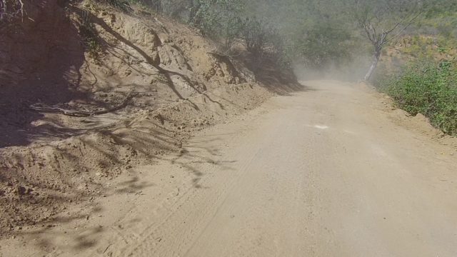 LOS CABOS BCS MEXICO-2022: Dusty Dirt Road Winding Through Rocky Hills