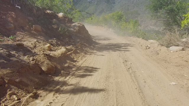 LOS CABOS BCS MEXICO-2022: Dirt Road Vehicle Passing Motorcyclist on Mountain Trail