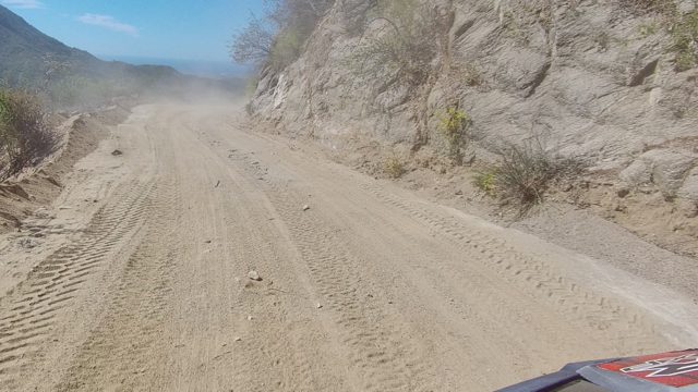 LOS CABOS BCS MEXICO-2022: Dusty Mountain Road View From Moving Vehicle