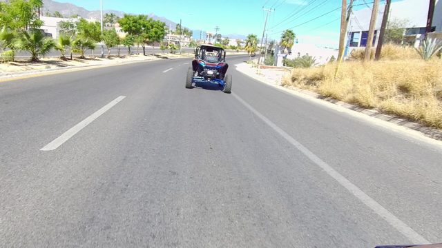LOS CABOS BCS MEXICO-2022: Dune Buggy and Red SUV Driving on a Street