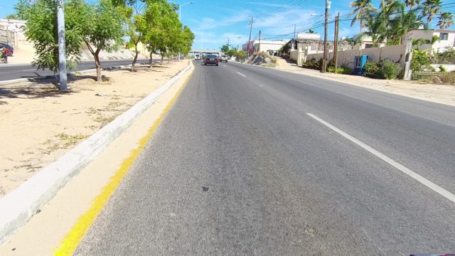 LOS CABOS BCS MEXICO-2022: Vehicle Driving on a Tree-lined Urban Road