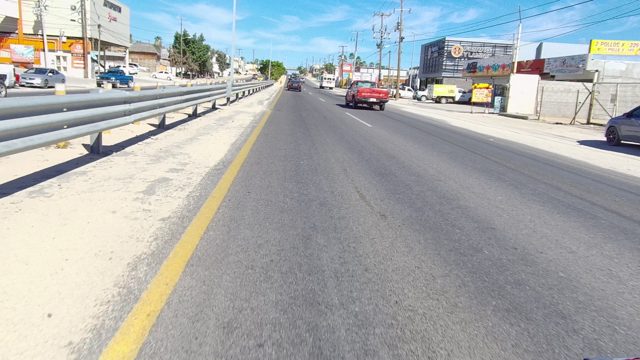 LOS CABOS BCS MEXICO-2022: Car Driving Along a Busy Urban Road with Passing Vehicles