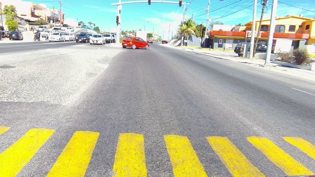LOS CABOS BCS MEXICO-2022: Vehicles Moving Through an Urban Intersection Crosswalk