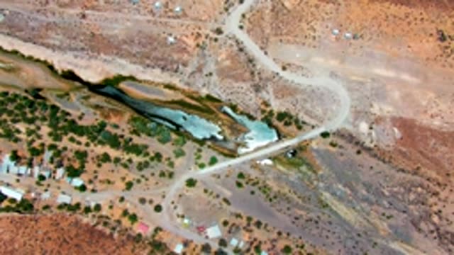 SAN JUANICO BCS MEXICO-2022: Arid Terrain with Winding Road and Shallow Water