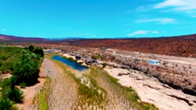 SAN JUANICO BCS MEXICO-2022: Aerial Approach to Small White Building in Arid Valley