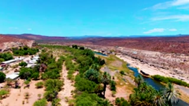 SAN JUANICO BCS MEXICO-2022: River Winding Through Arid Valley with Greenery