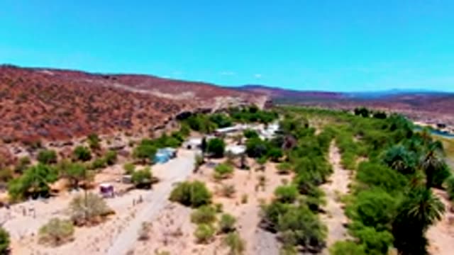 SAN JUANICO BCS MEXICO-2022: Aerial Pan of Desert River and Sparse Vegetation