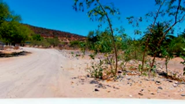 SAN JUANICO BCS MEXICO-2022: Dusty Dirt Road Moving Through Arid Landscape
