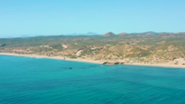 EL TULE LOS CABOS BCS MEXICO-2022: Coastal Shore with Boats Moving in Clear Waters