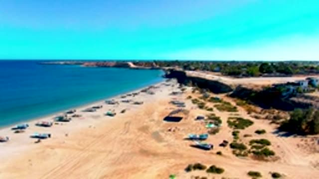 SAN JUANICO BCS MEXICO-2022: Sandy Beach with Boats and a Moving Vessel