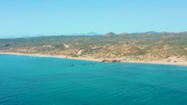 EL TULE LOS CABOS BCS MEXICO-2022: Coastal Waters Lapping a Sandy Shore with Rolling Hills
