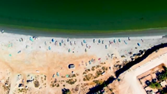 SAN JUANICO BCS MEXICO-2022: People Relaxing on Sandy Beach with Gentle Waves