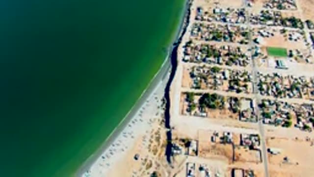SAN JUANICO BCS MEXICO-2022: Beach Road with Moving Vehicles and Residential Neighborhood
