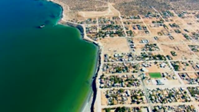 SAN JUANICO BCS MEXICO-2022: Tide Receding Along Sandy Beach and Residential Area