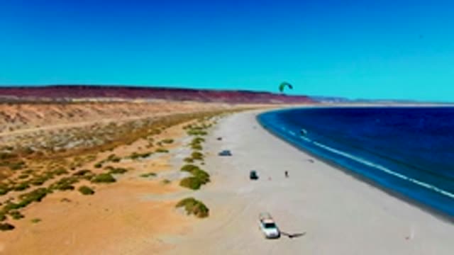 SAN JUANICO BCS MEXICO-2022: Kite Surfers and Vehicles on a Desert Beach
