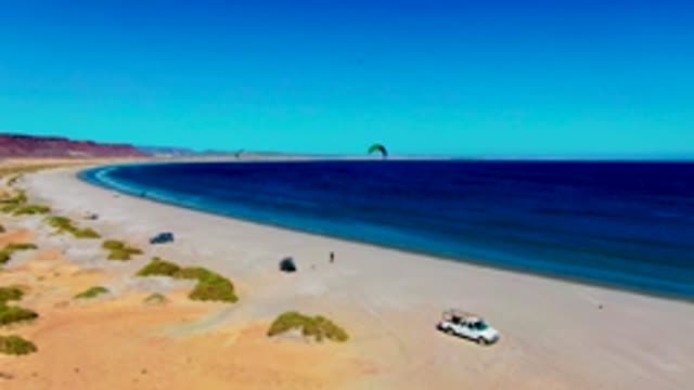 SAN JUANICO BCS MEXICO-2022: Kite Surfers on a Desert-adjacent Sandy Beach