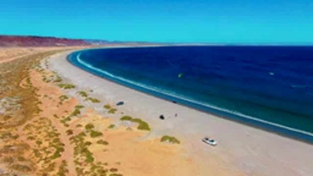 SAN JUANICO BCS MEXICO-2022: Desert Beach Shoreline with Surfers and Ocean Waves