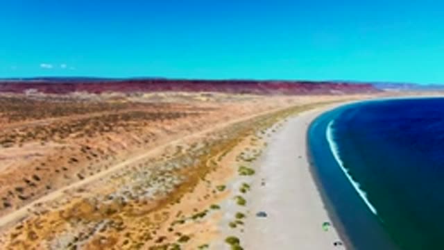SAN JUANICO BCS MEXICO-2022: Kite Surfers Gliding Along Desert Beach