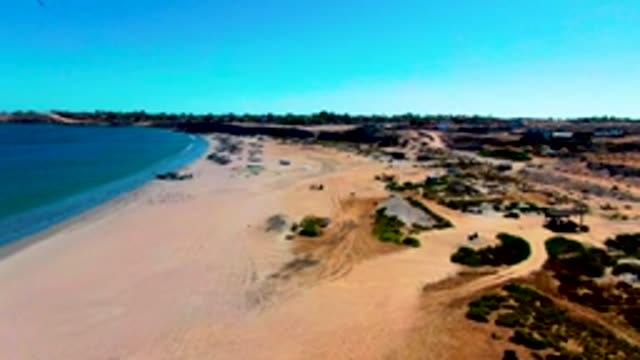 SAN JUANICO BCS MEXICO-2022: Car Driving Away From Sandy Beach