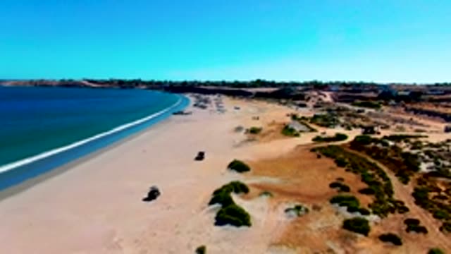 SAN JUANICO BCS MEXICO-2022: 4x4 Vehicle Driving Along Sandy Beach