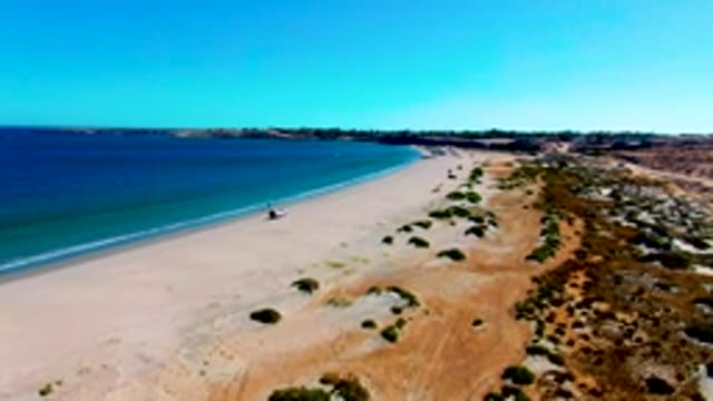 SAN JUANICO BCS MEXICO-2022: 4x4 Vehicle Driving on Sandy Beach Shore