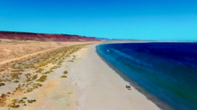 SAN JUANICO BCS MEXICO-2022: Vehicle Driving Along Desert Beach Shoreline