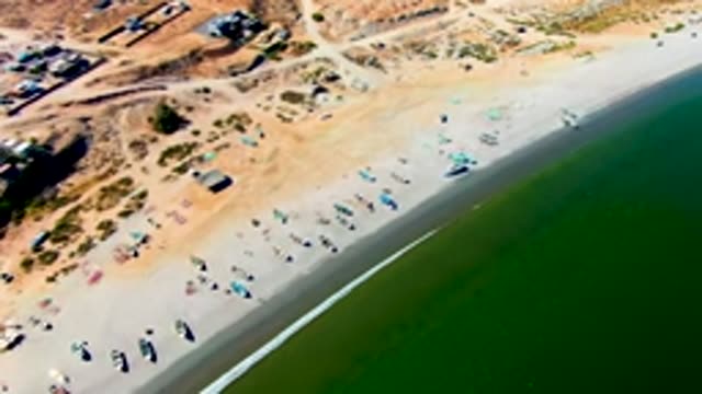 SAN JUANICO BCS MEXICO-2022: Receding Tide Exposes Sandy Beach with Fishing Boats