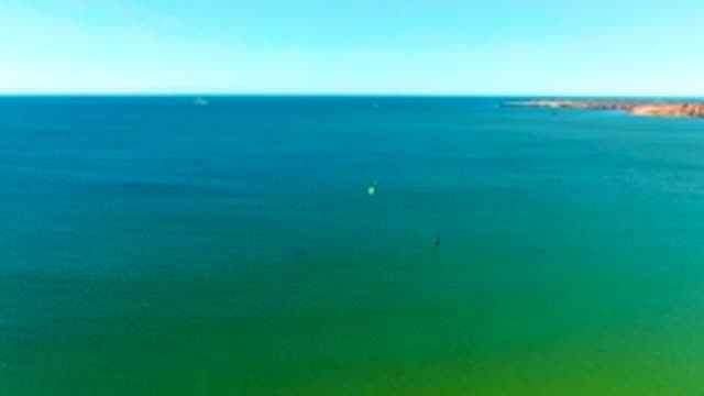 SAN JUANICO BCS MEXICO-2022: Kite Surfers Moving Across the Ocean Surface
