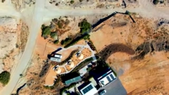 SAN JUANICO BCS MEXICO-2022: Vehicle Driving on Arid Dirt Road Near House