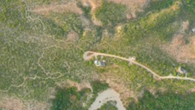 CABO PULMO LOS CABOS BCS MEXICO-2022: Vehicle Moving Along a Dirt Road in Hilly Terrain