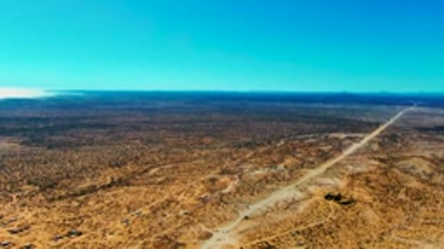 SAN JUANICO BCS MEXICO-2022: Desert Road Leading to Coastal Settlement