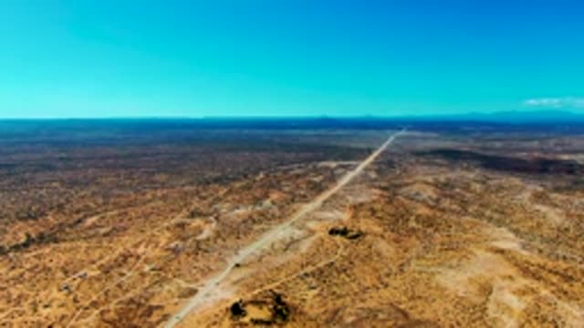 SAN JUANICO BCS MEXICO-2022: Desert Runway with Moving Vehicle and Distant Mountains