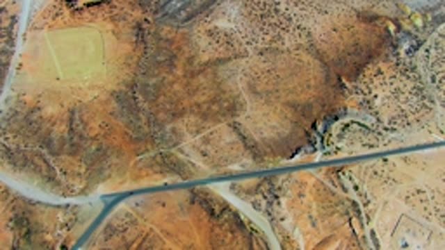 SAN JUANICO BCS MEXICO-2022: Vehicle Moving Along Road Near Airfield in Arid Terrain