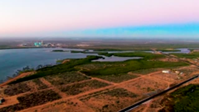 SAN CARLOS BCS MEXICO-2022: Vehicle Moving Along a Rural Road by Water
