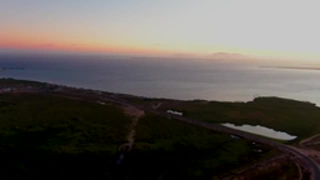 SAN CARLOS BCS MEXICO-2022: Coastal Road at Sunset with Moving Vehicle