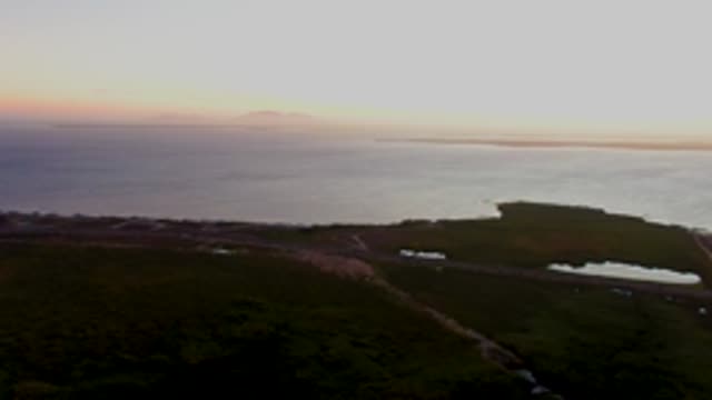 SAN CARLOS BCS MEXICO-2022: Vehicle Moving Along Coastal Path at Dusk