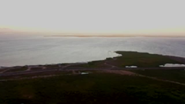SAN CARLOS BCS MEXICO-2022: Aerial Pan of Coastal Water and Green Land