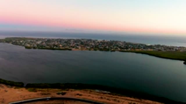SAN CARLOS BCS MEXICO-2022: Coastal Town at Sunset with Moving Car