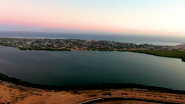 SAN CARLOS BCS MEXICO-2022: Coastal Town and Road with Passing Cars