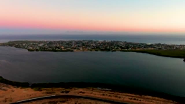 SAN CARLOS BCS MEXICO-2022: Coastal Town at Dusk with Moving Vehicle